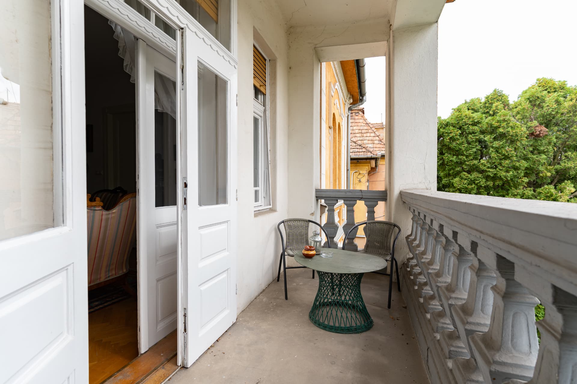 The apartment balcony with a small table and chairs